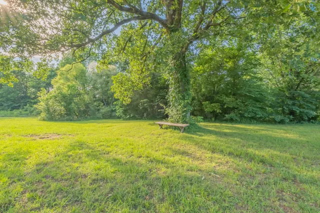 a large kitchen with stainless steel appliances granite countertop a sink and cabinets