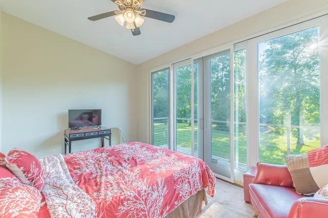a living room with furniture and a floor to ceiling window