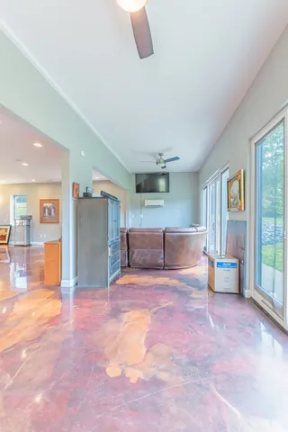 a view of a livingroom with furniture and a window