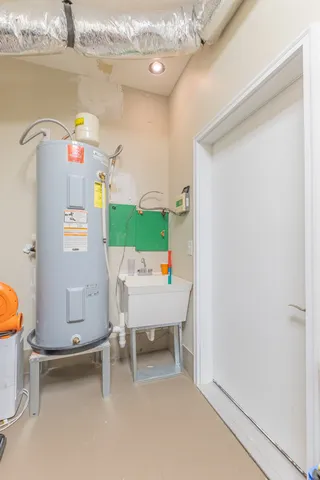 a white toilet sitting next to a white wall