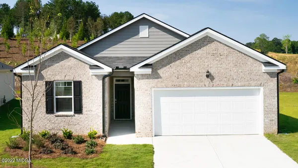 a view of small house with yard