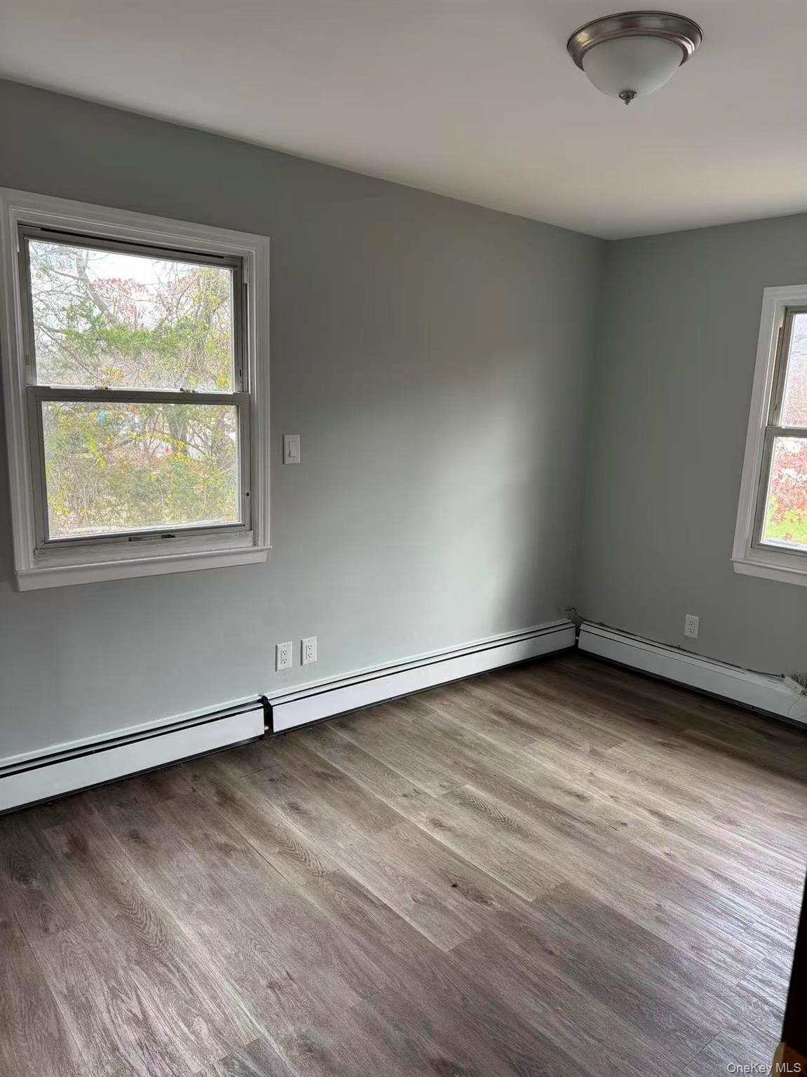 20 Westfield Road Coram, NY 11727 - Photo 11 of 21 an empty room with wooden floor and windows
