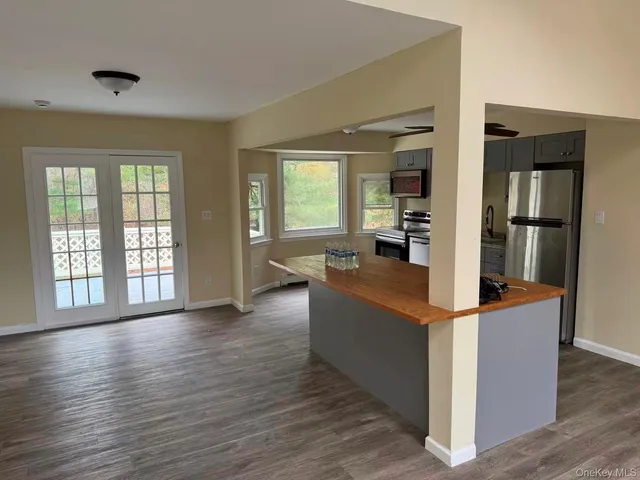 a living room with furniture and large windows