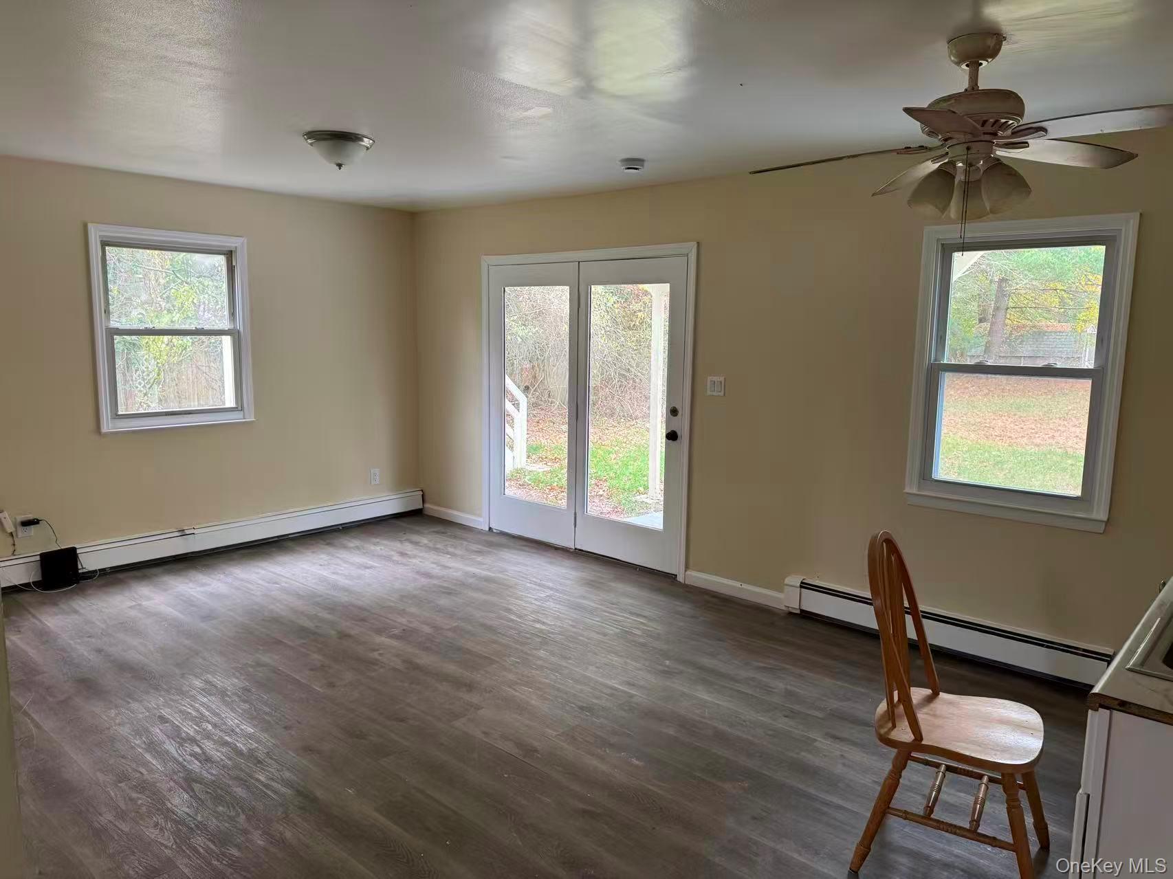 20 Westfield Road Coram, NY 11727 - Photo 3 of 21 a view of workspace with wooden floor ceiling fan and windows