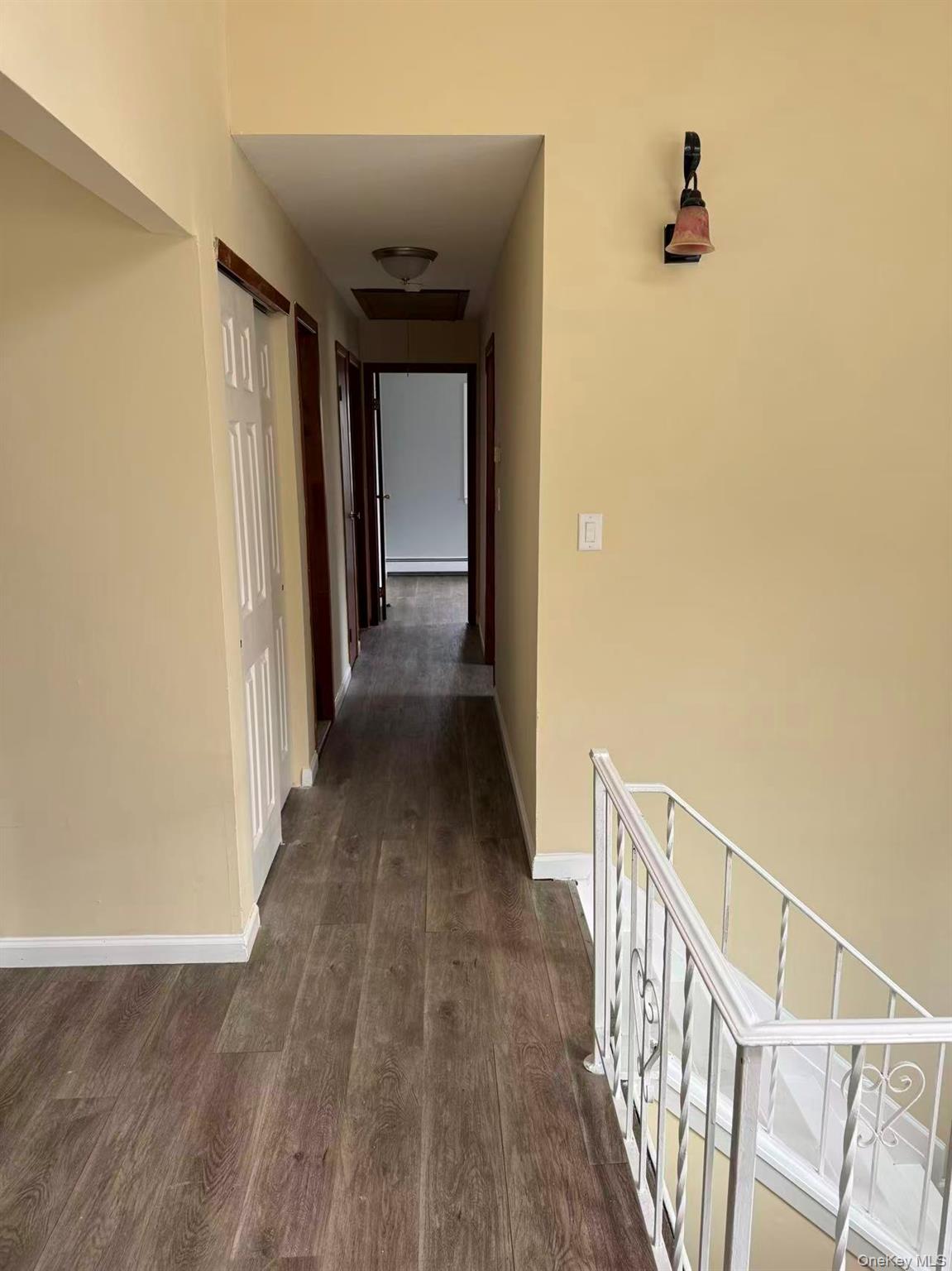 20 Westfield Road Coram, NY 11727 - Photo 7 of 21 a view of a hallway with wooden floor and stairs