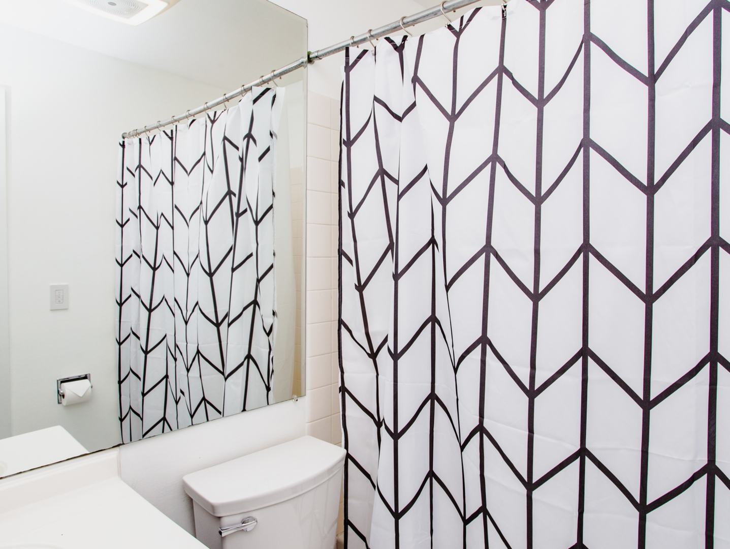 1400 North Elmhurst Road, Unit 213 Mount Prospect, IL 60056 - Photo 12 of 14 a bathroom with a shower curtain and a toilet sink