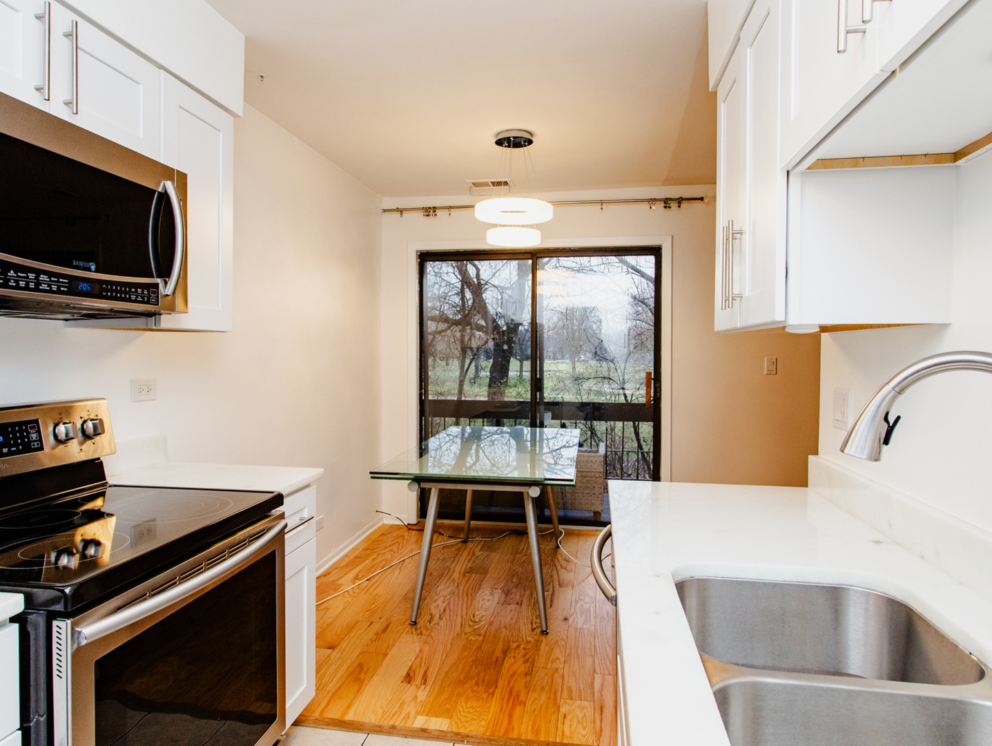 1400 North Elmhurst Road, Unit 213 Mount Prospect, IL 60056 - Photo 5 of 14 a kitchen with a stove a sink and a microwave