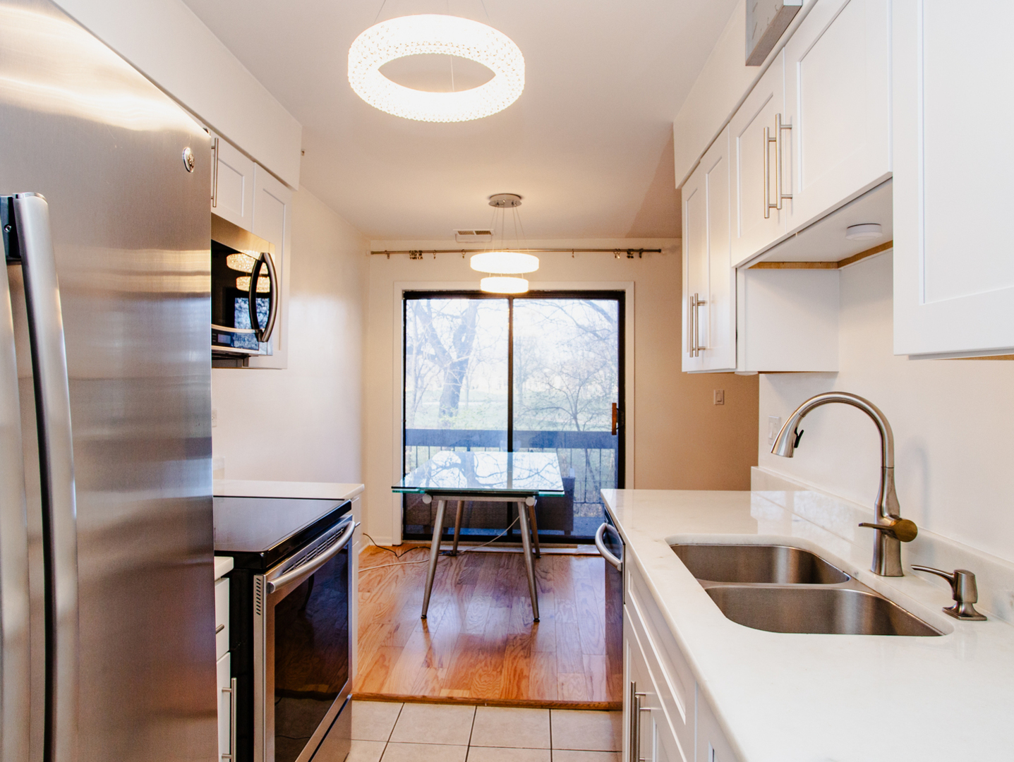 1400 North Elmhurst Road, Unit 213 Mount Prospect, IL 60056 - Photo 6 of 14 a kitchen with kitchen island a large counter top space a sink stainless steel appliances and cabinets