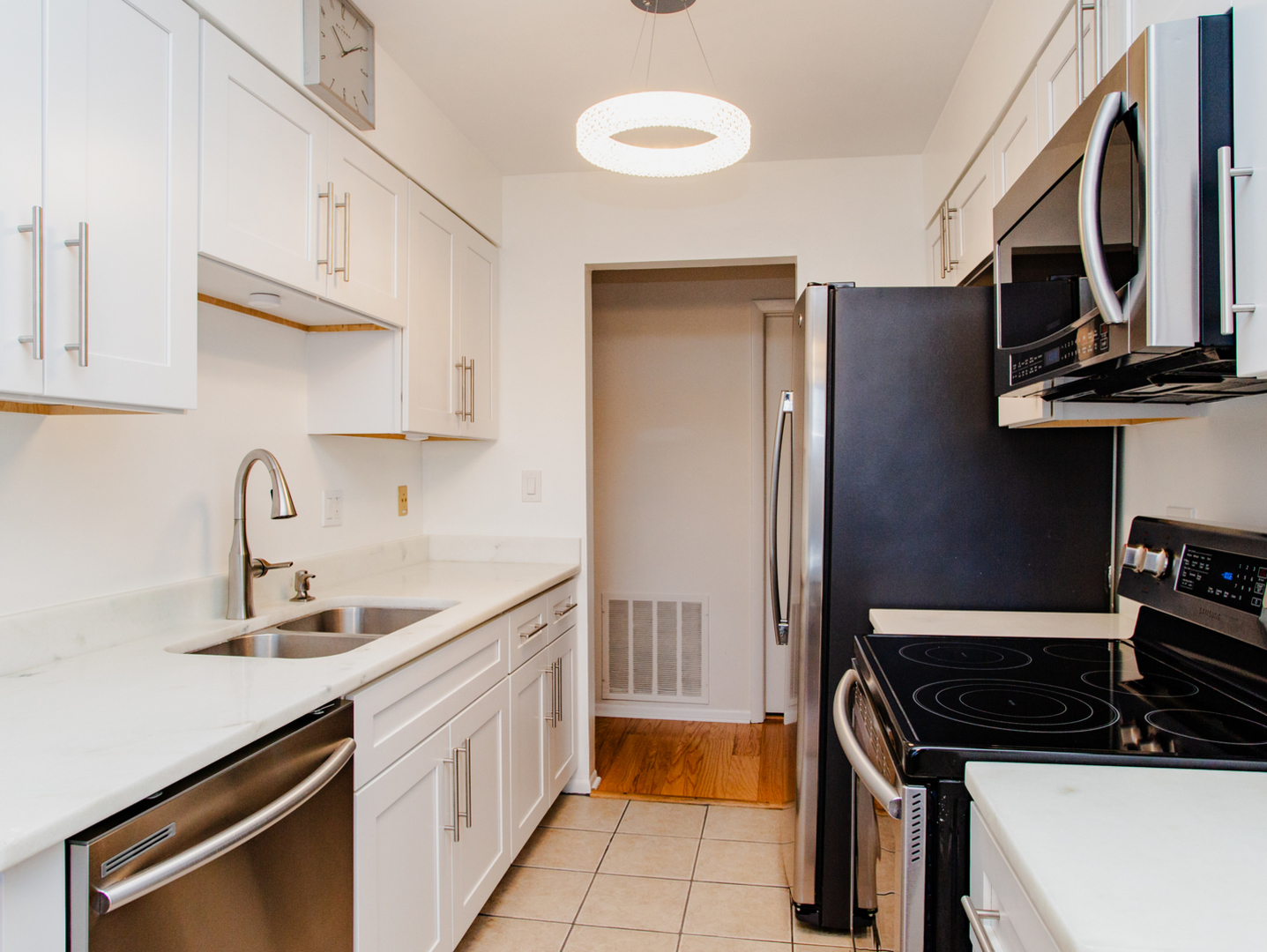1400 North Elmhurst Road, Unit 213 Mount Prospect, IL 60056 - Photo 7 of 14 a kitchen with stainless steel appliances granite countertop a sink stove and cabinets