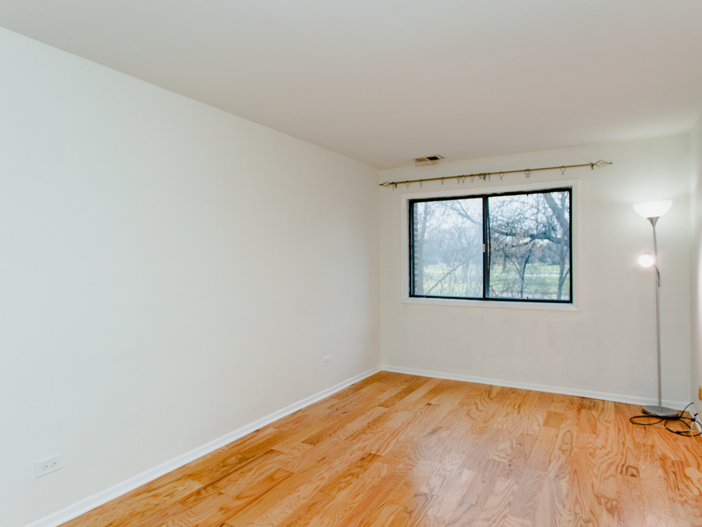 1400 North Elmhurst Road, Unit 213 Mount Prospect, IL 60056 - Photo 9 of 14 an empty room with a window