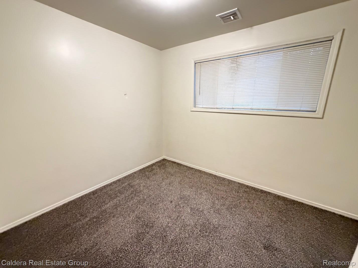 15354 Lahser Road Detroit, MI 48223 - Photo 10 of 10 Unfurnished room featuring carpet floors and baseboards