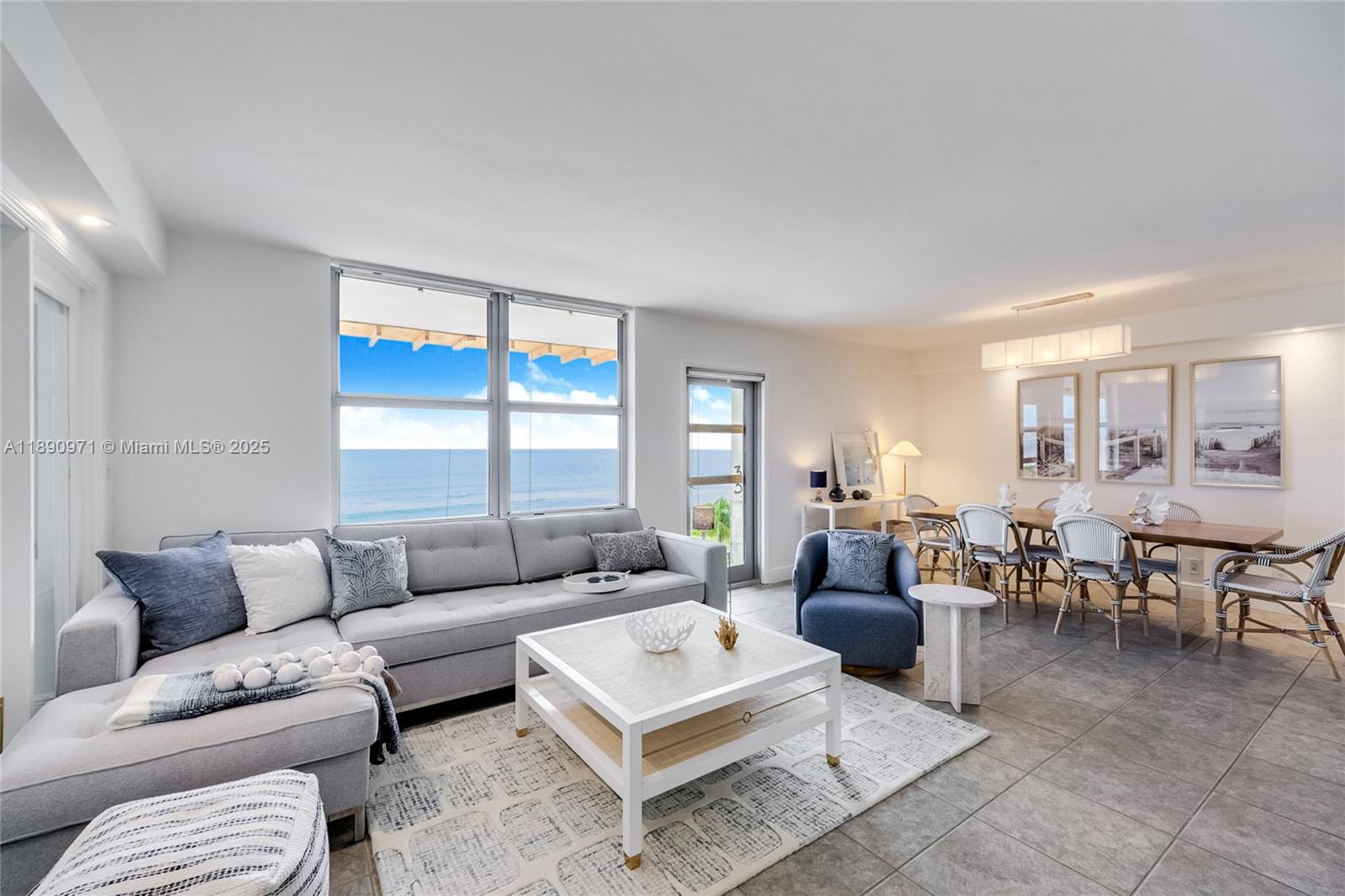 9225 Collins Avenue, Unit 501 Surfside, FL 33154 - Photo 2 of 12 a living room with furniture a rug and a window