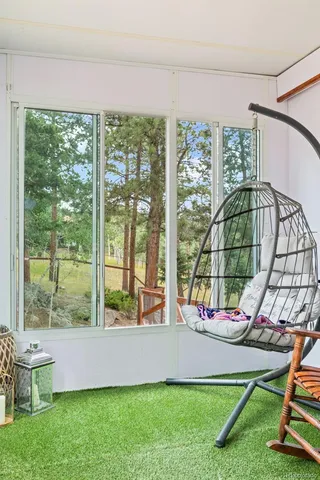 a living room with a floor to ceiling window and pool