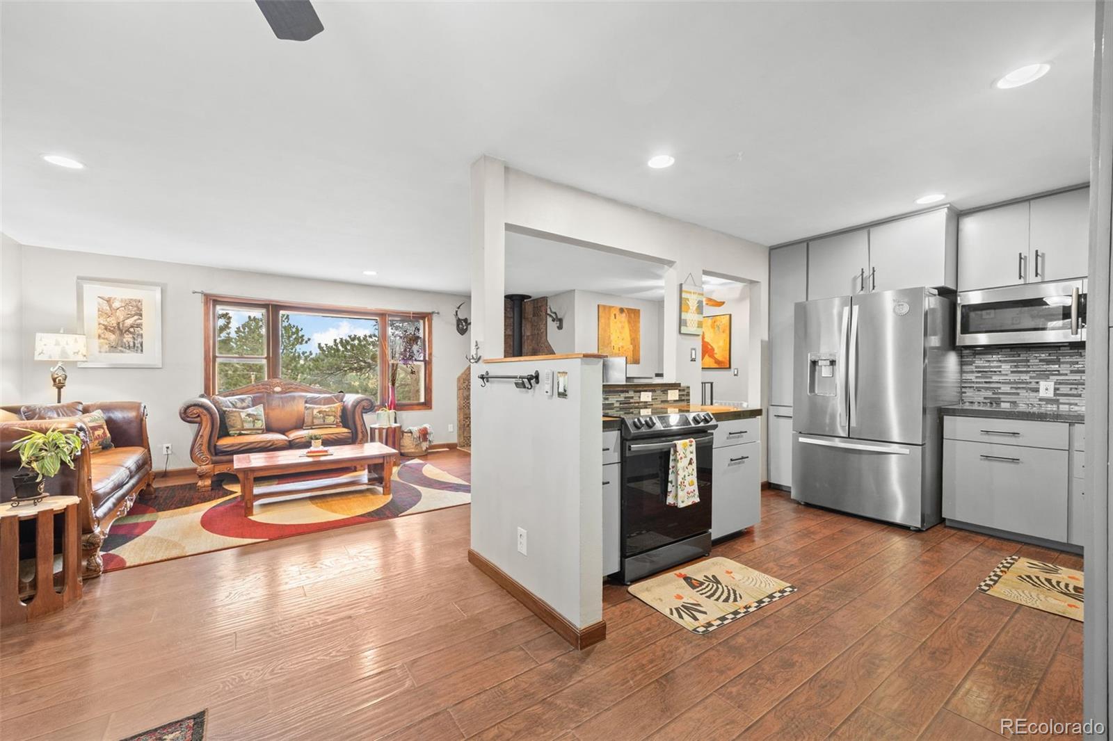 41 Yew Lane Bailey, CO 80421 - Photo 12 of 47 a kitchen with stainless steel appliances a refrigerator a stove a sink dishwasher a oven with white cabinets and wooden floor