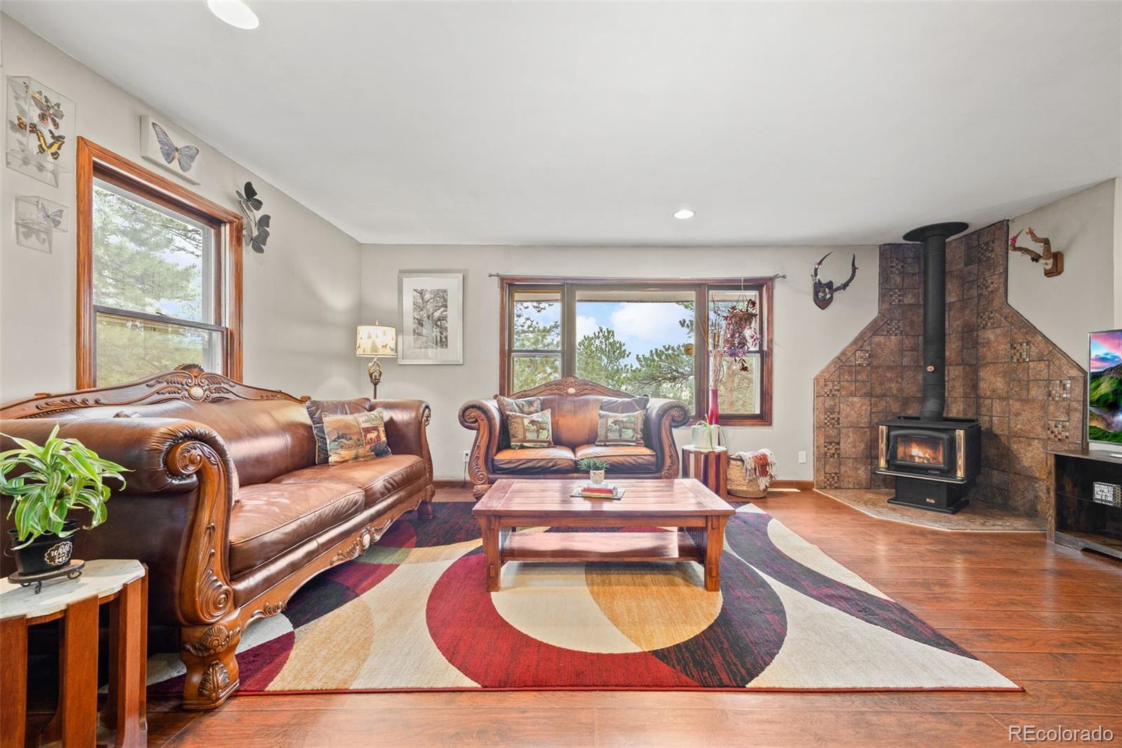 41 Yew Lane Bailey, CO 80421 - Photo 13 of 47 a living room with furniture fireplace and a large window