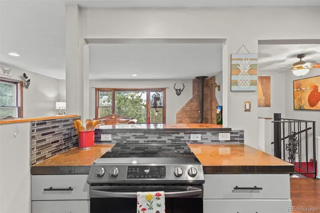 a kitchen with stainless steel appliances granite countertop a stove and a sink
