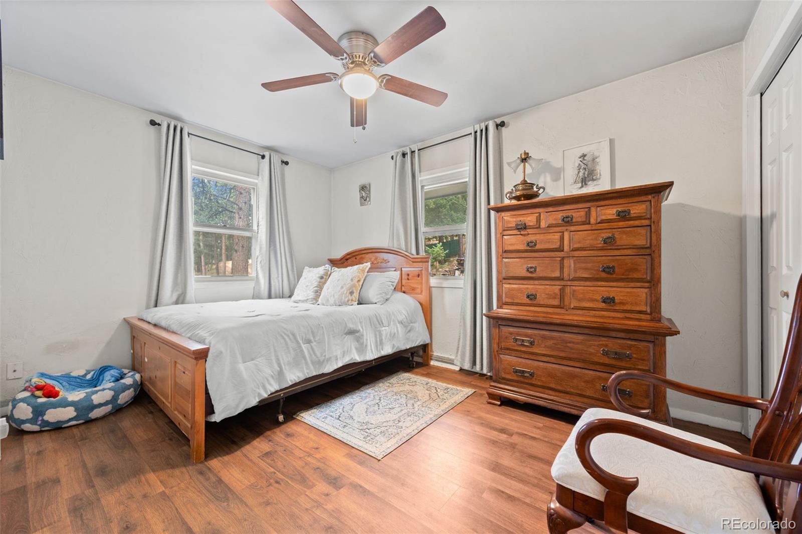 41 Yew Lane Bailey, CO 80421 - Photo 29 of 47 a bedroom with a bed and a chandelier