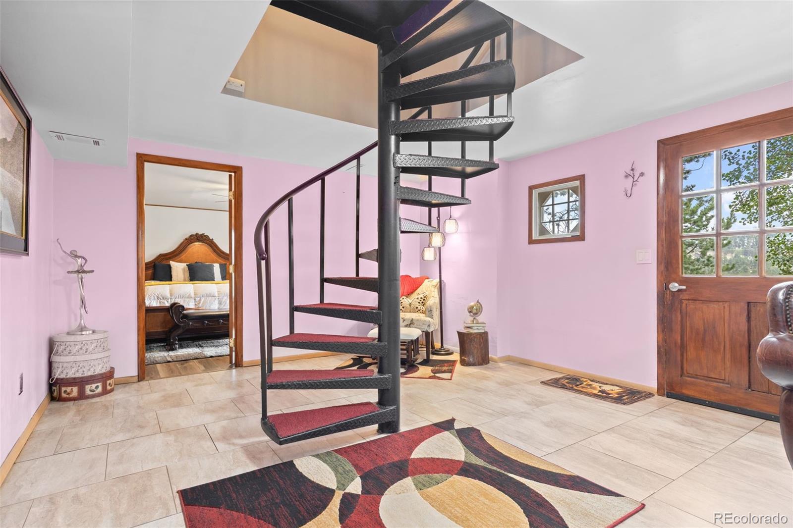 41 Yew Lane Bailey, CO 80421 - Photo 31 of 47 a bedroom with a bed and a chandelier