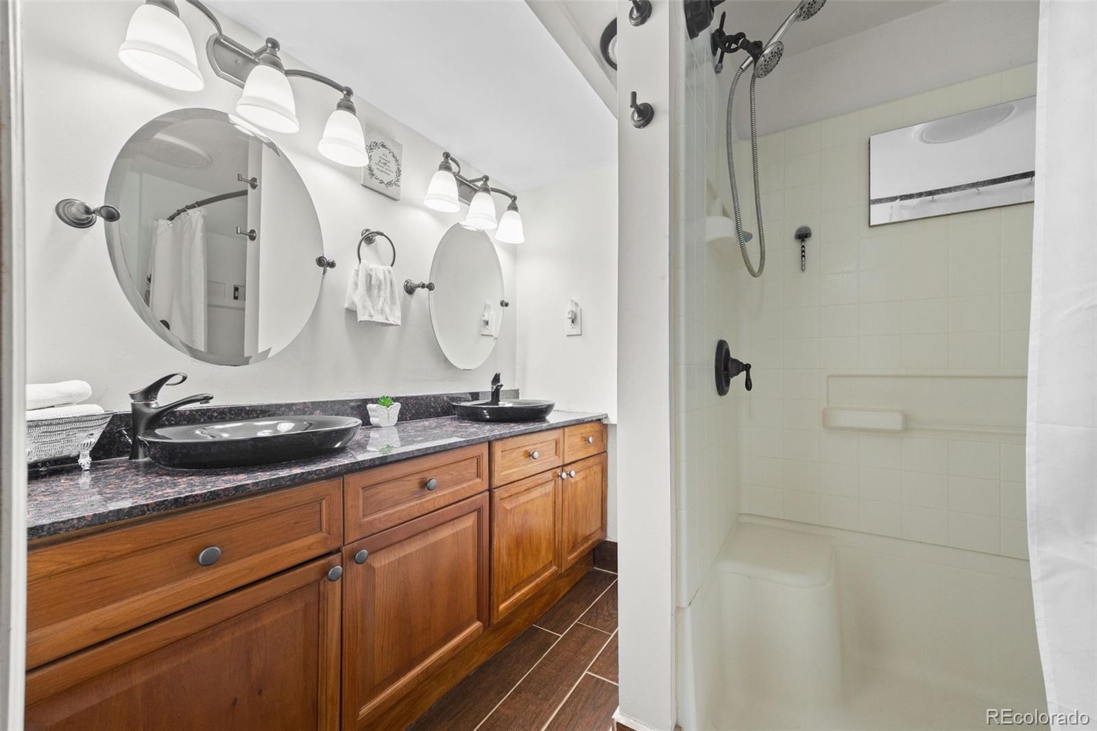 41 Yew Lane Bailey, CO 80421 - Photo 36 of 47 a bathroom with a granite countertop sink a mirror and shower