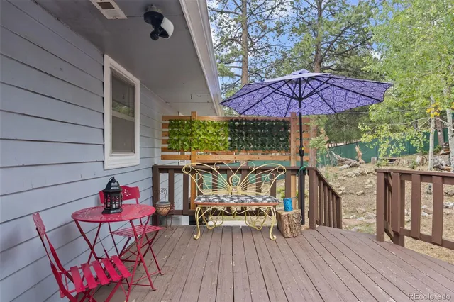 an outdoor sitting area with furniture and wooden floor