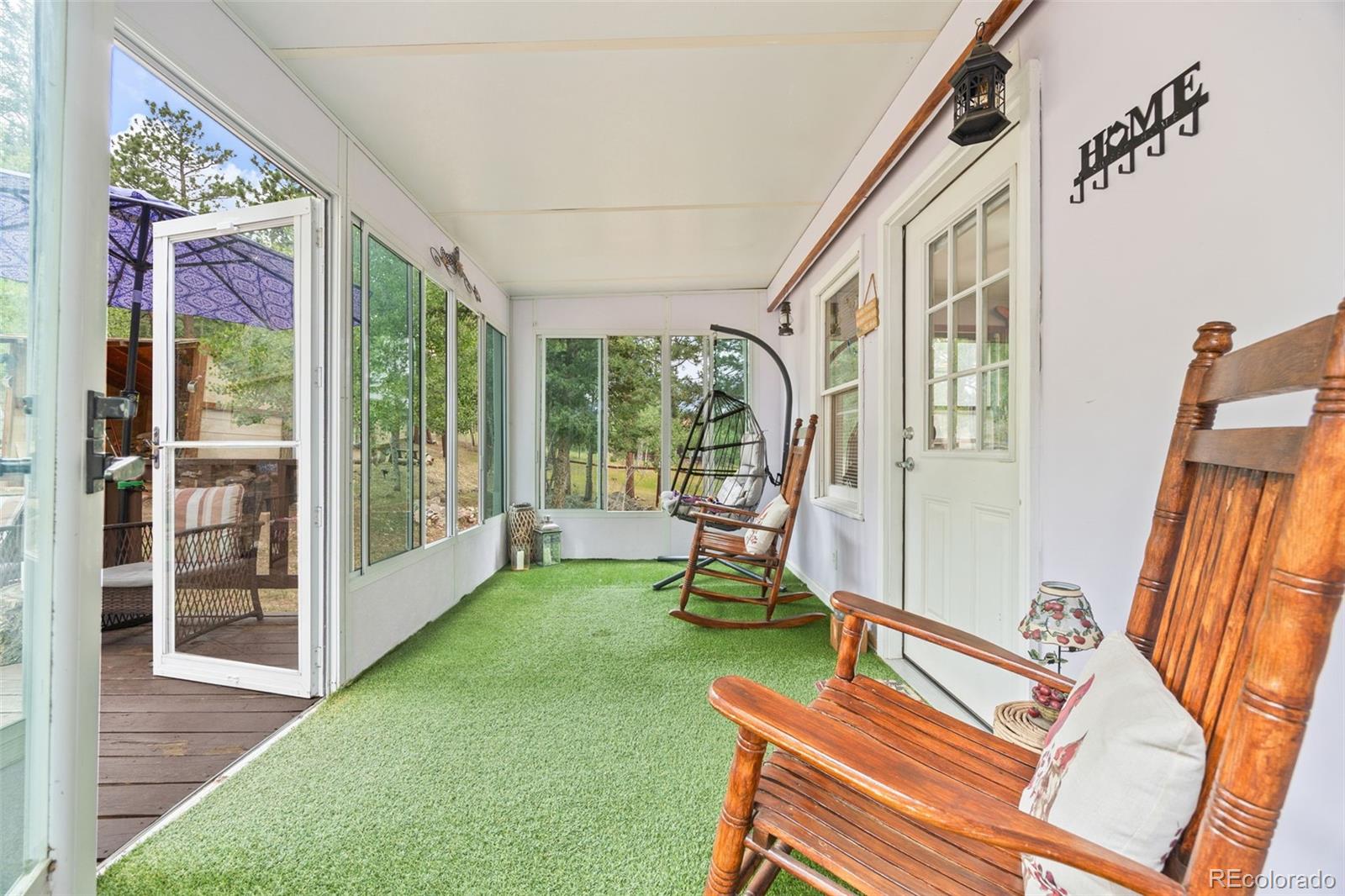 41 Yew Lane Bailey, CO 80421 - Photo 10 of 47 a living room with furniture and a floor to ceiling window