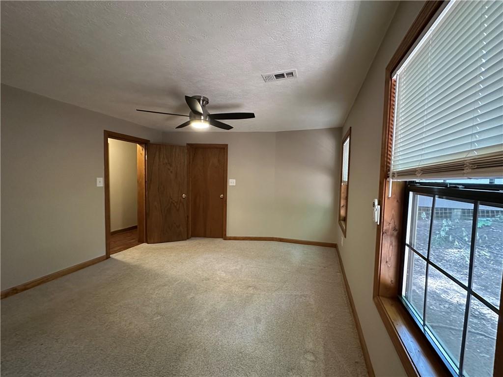 710 Spiva Road Temple, GA 30179 - Photo 20 of 31 an empty room with wooden floor and windows