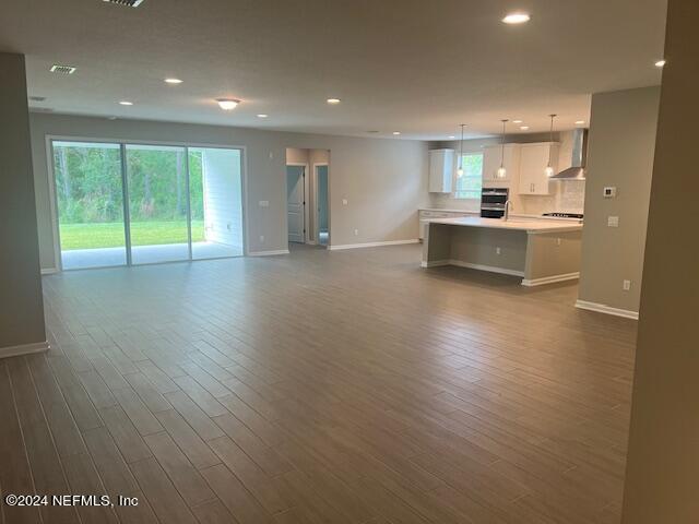 47 Archstone Way Street, Unit 3 St. Augustine, FL 32092 - Photo 2 of 19 a view of kitchen with wooden floor and windows