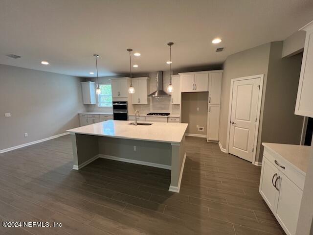 47 Archstone Way Street, Unit 3 St. Augustine, FL 32092 - Photo 3 of 19 a room with stainless steel appliances kitchen island sink refrigerator and cabinets