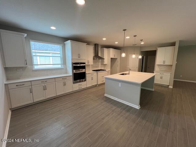 47 Archstone Way Street, Unit 3 St. Augustine, FL 32092 - Photo 4 of 19 a large white kitchen with a large window a sink and stainless steel appliances