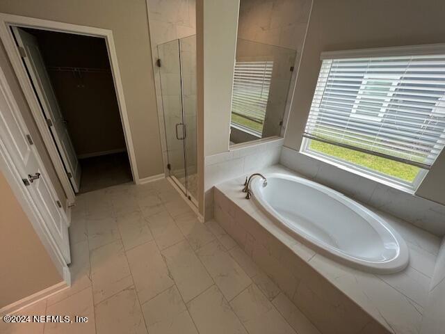 47 Archstone Way Street, Unit 3 St. Augustine, FL 32092 - Photo 7 of 19 a bathroom with a tub a sink and a large window