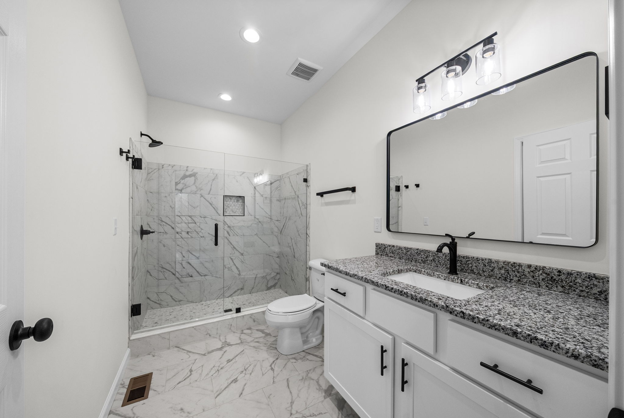 690 Brazzle Road Waverly, TN 37185 - Photo 19 of 35 a bathroom with a granite countertop sink a toilet a mirror and shower