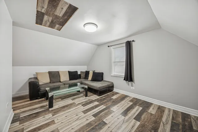 a bedroom with furniture and wooden floor