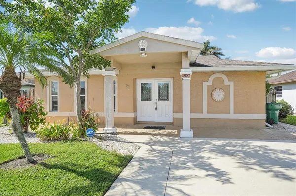 a front view of a house with garden