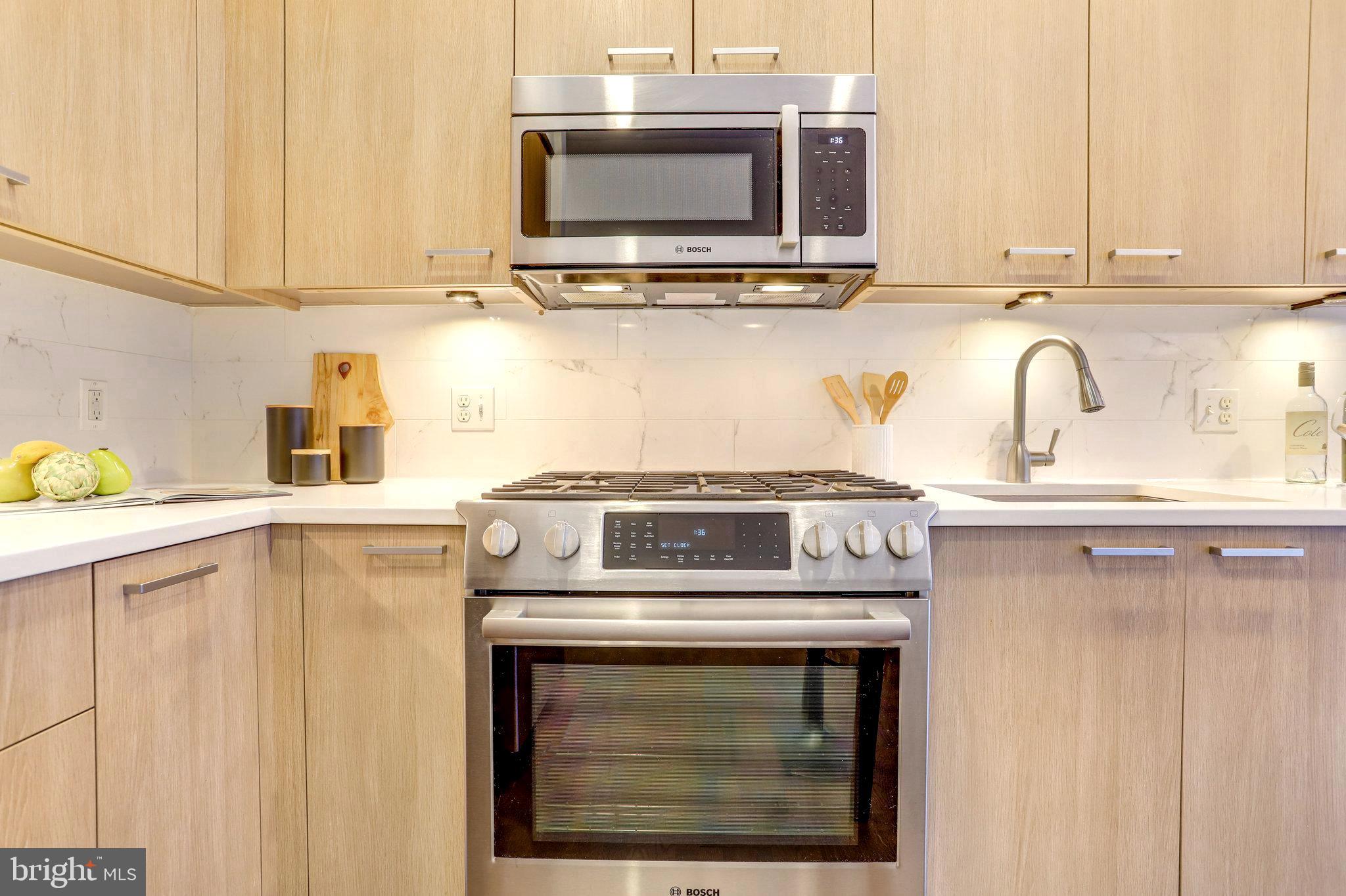 525 Water Street Southwest, Unit 223 Washington, DC 20024 - Photo 12 of 68 a stove top oven sitting inside of a kitchen