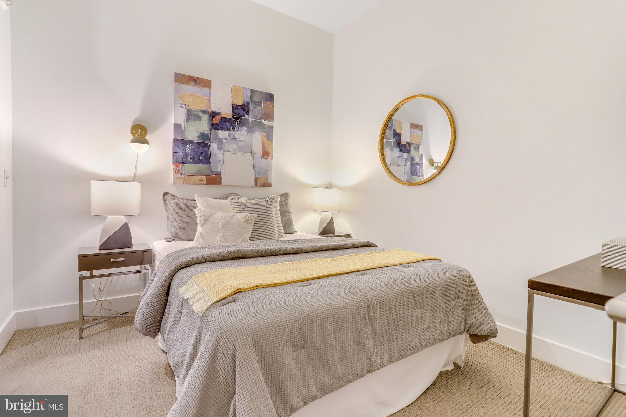 525 Water Street Southwest, Unit 223 Washington, DC 20024 - Photo 13 of 68 a bedroom with bed and a lamp