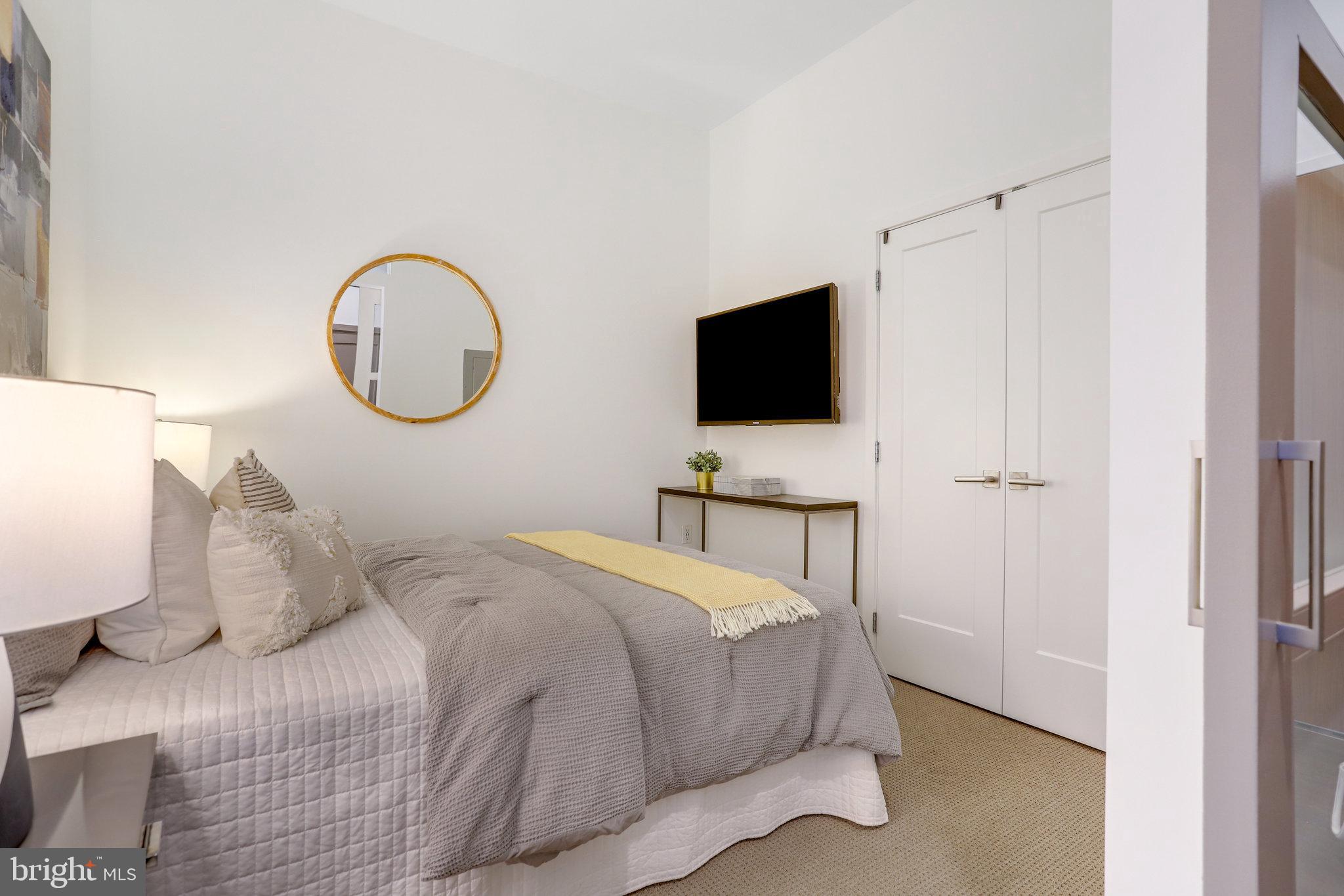 525 Water Street Southwest, Unit 223 Washington, DC 20024 - Photo 14 of 68 a bedroom with a bed and a flat screen tv