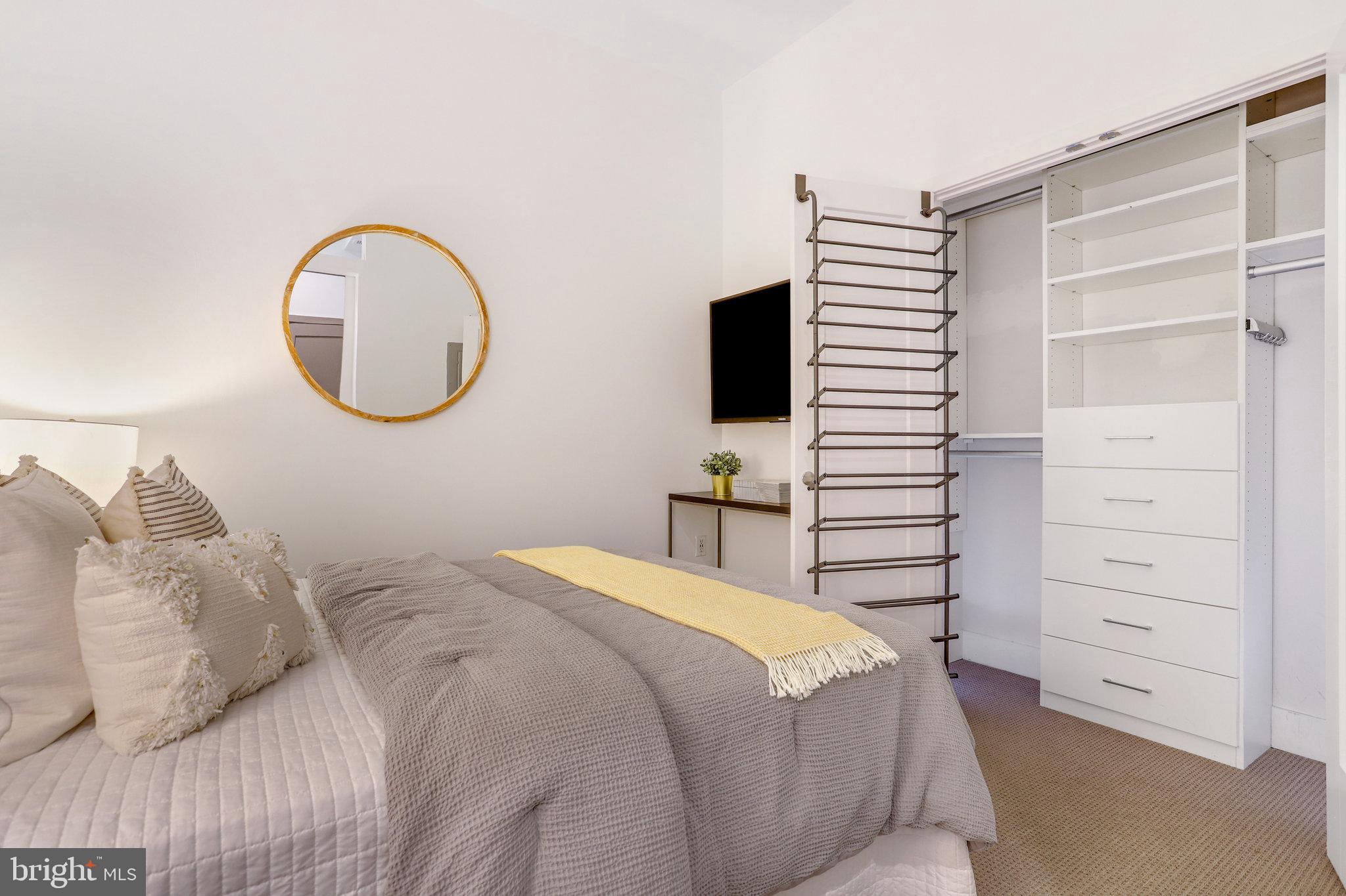 525 Water Street Southwest, Unit 223 Washington, DC 20024 - Photo 15 of 68 a bedroom with a bed and a television