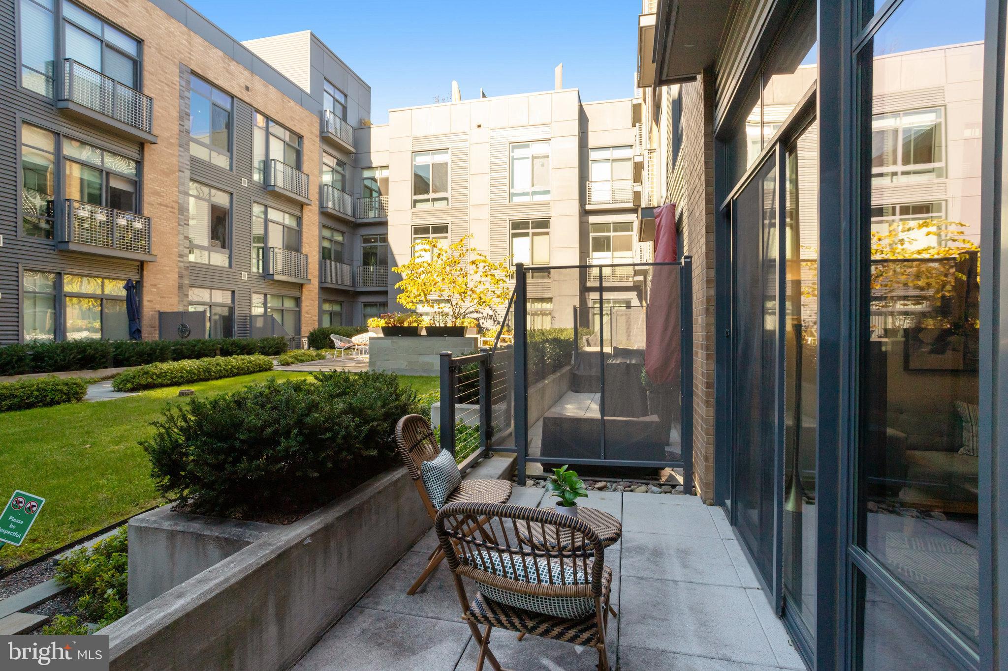 525 Water Street Southwest, Unit 223 Washington, DC 20024 - Photo 29 of 68 a front view of a house with a garden and patio