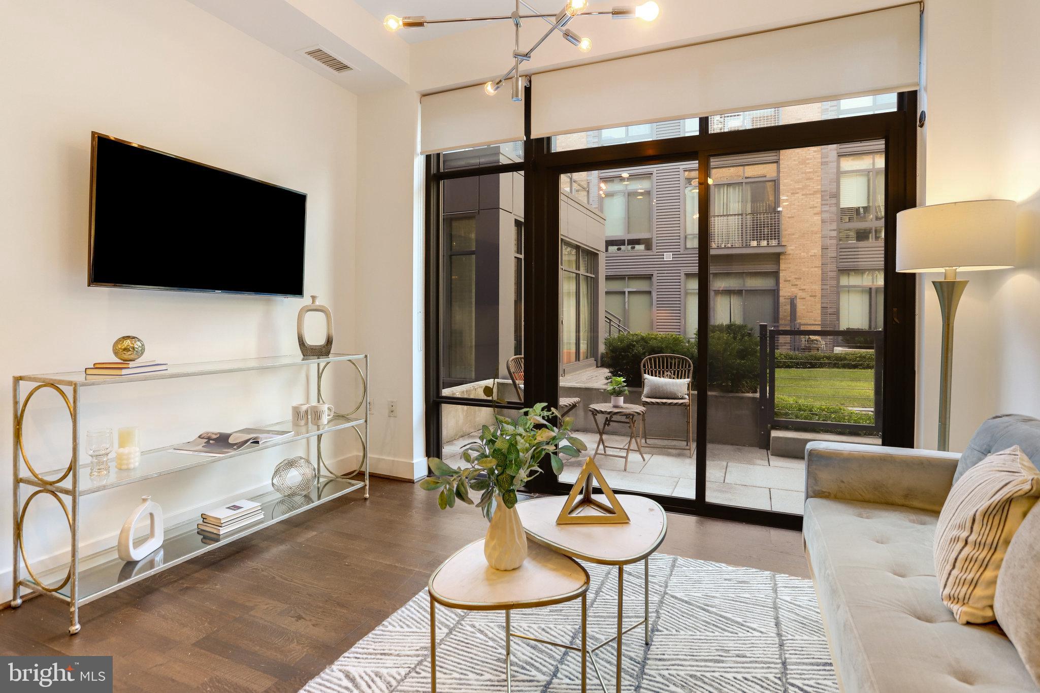 525 Water Street Southwest, Unit 223 Washington, DC 20024 - Photo 10 of 68 a living room with furniture and a flat screen tv