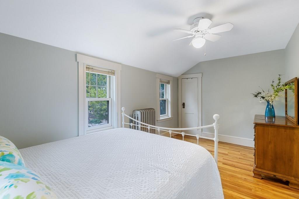44 Sutherland Road Arlington, MA 02476 - Photo 14 of 21 a bedroom with a bed and a chandelier