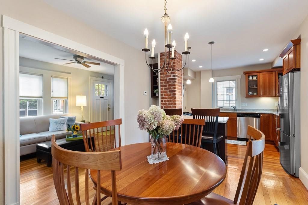 44 Sutherland Road Arlington, MA 02476 - Photo 9 of 21 a dining room with furniture a chandelier and wooden floor