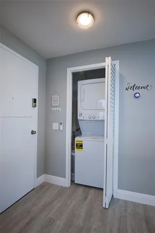 an empty room with wooden door and mirror