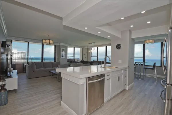 a large white kitchen with a large window