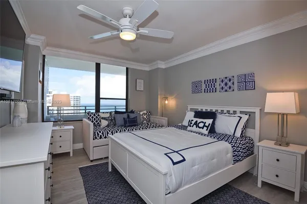 a bed room with a bed and a large window