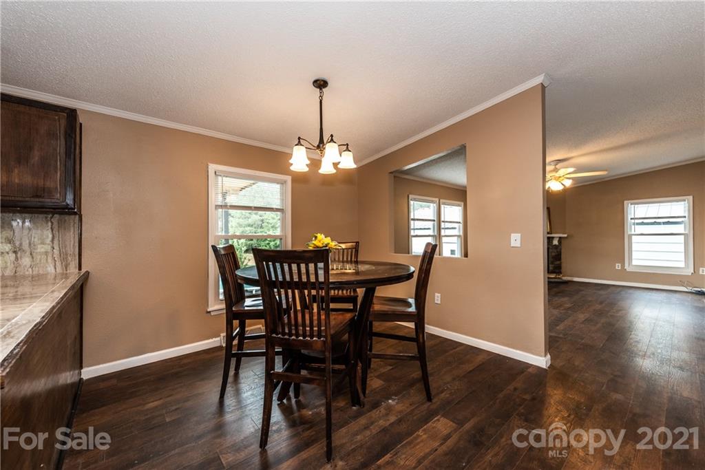 4638 Barrier Road Concord, NC 28025 - Photo 14 of 43 a view of a dining room with furniture and wooden floor