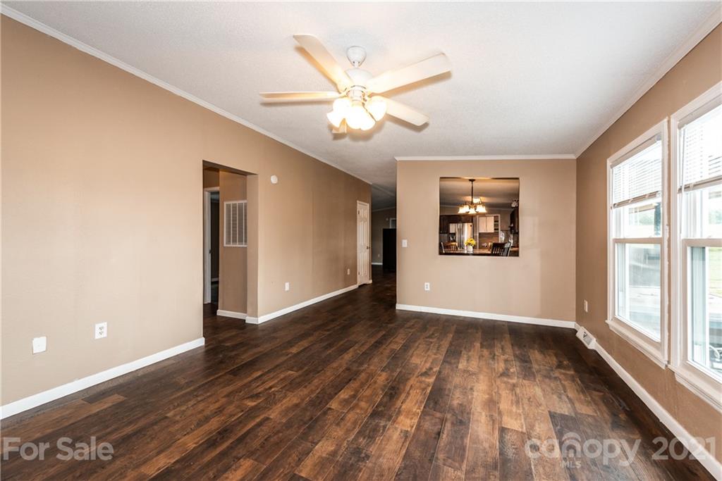 4638 Barrier Road Concord, NC 28025 - Photo 18 of 43 an empty room with wooden floor fan and windows