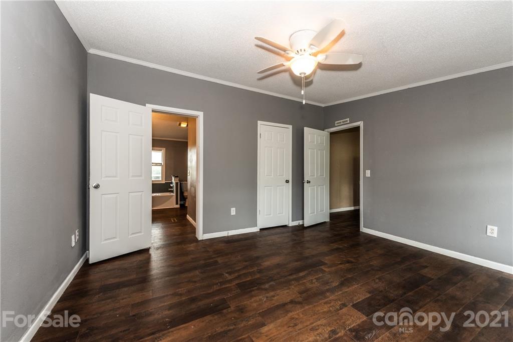 4638 Barrier Road Concord, NC 28025 - Photo 21 of 43 an empty room with wooden floor and ceiling fan