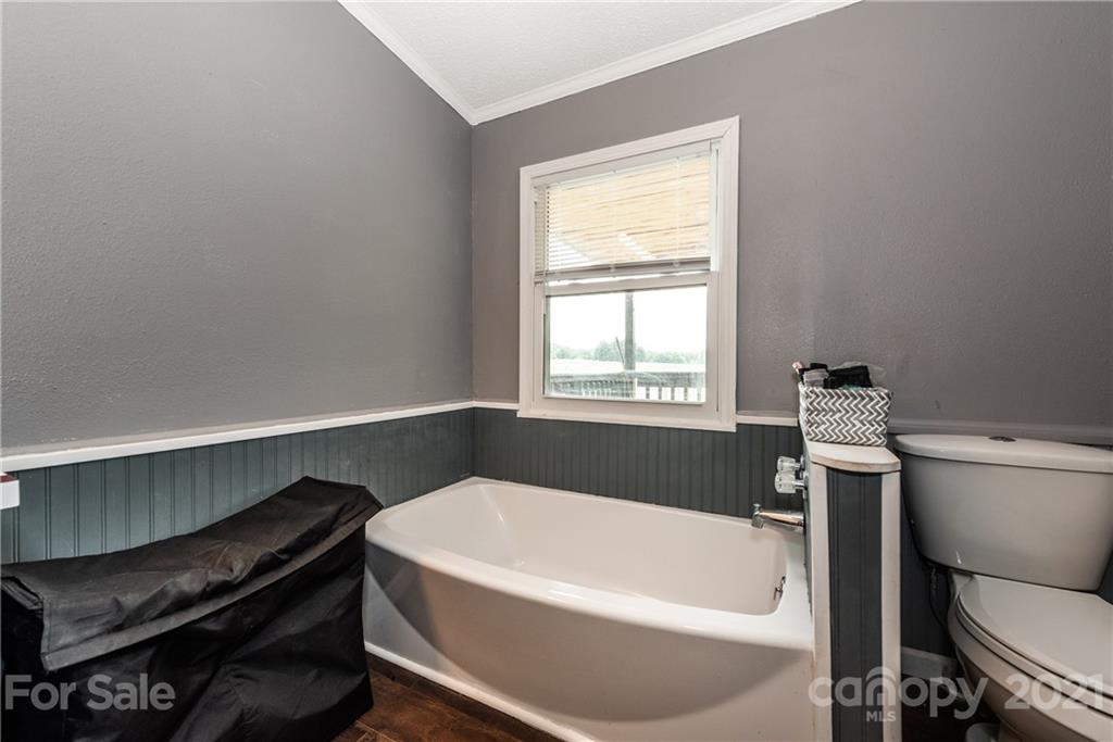 4638 Barrier Road Concord, NC 28025 - Photo 24 of 43 a bathroom with a bathtub and a toilet