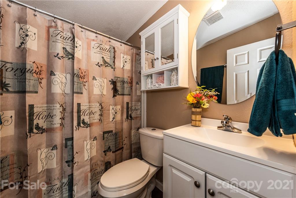 4638 Barrier Road Concord, NC 28025 - Photo 28 of 43 a bathroom with a sink toilet and shower
