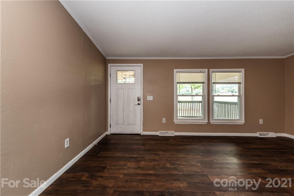 4638 Barrier Road Concord, NC 28025 - Photo 4 of 43 a view of an empty room with wooden floor and a window